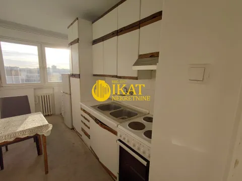Smaller kitchen with white cabinets and a dining table by the window. - image 5