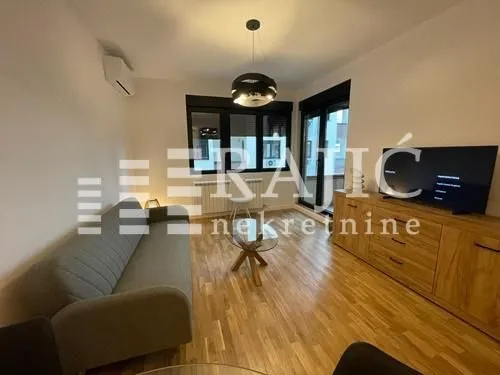 Living room with sofa, commode, and television.
