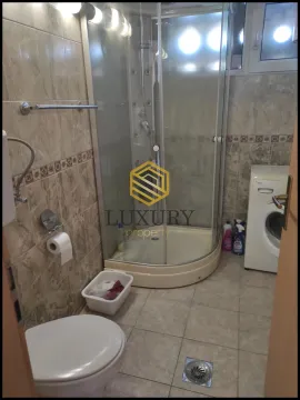 Small equipped bathroom with a shower cabin and washing machine. - image 10