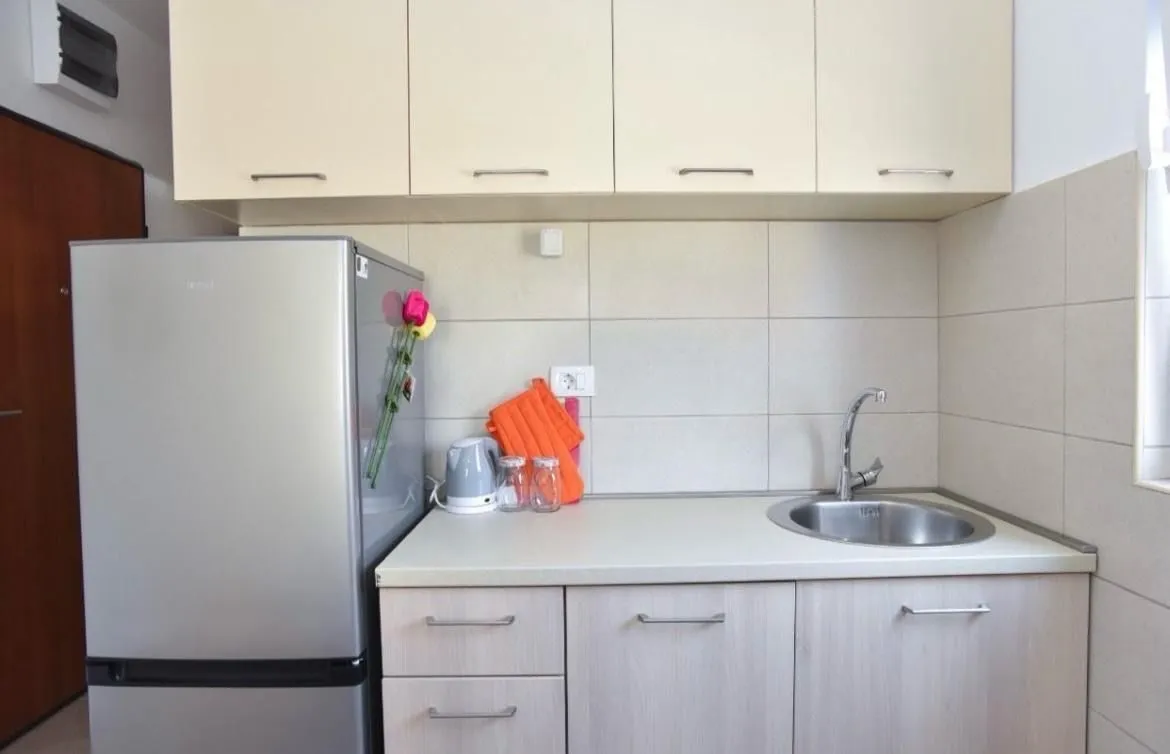 Small kitchen with cabinets and a sink.