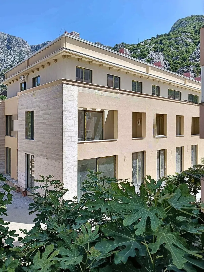 View of the building exterior with mountains in the background.