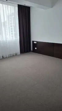 An empty room with grey carpeting, a large window, and dark curtains. - image 3