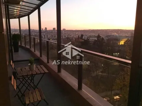 Glazed balcony with outdoor seating and a city view. - image 9
