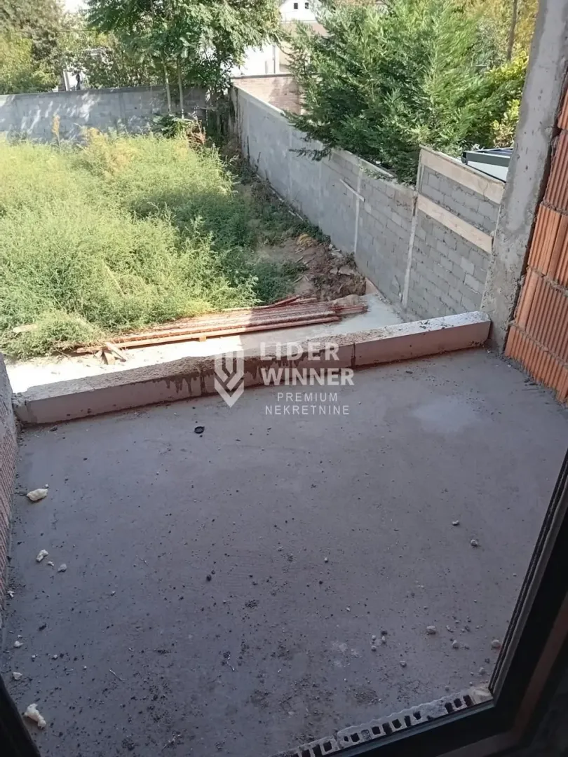 Unfinished balcony overlooking the yard under construction.