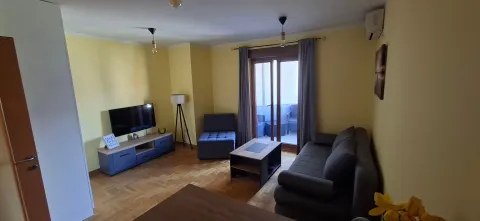 Furnished living room with a sofa, TV, and access to the terrace. - image 2