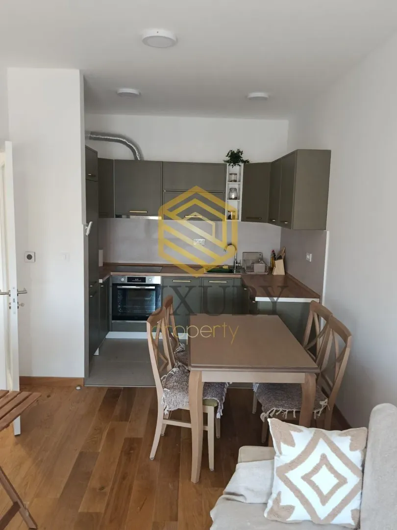 Smaller kitchen with a dining table and chairs as part of the living area.
