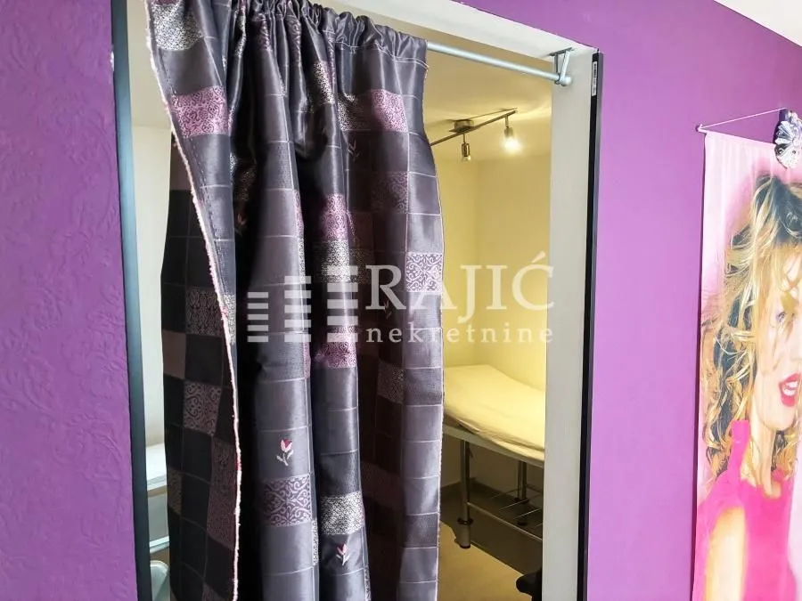 View of a room through a doorway with a curtain.