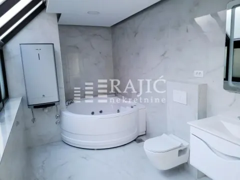 Modern bathroom equipped with a corner bathtub, washbasin, and sanitary fixtures. - image 11