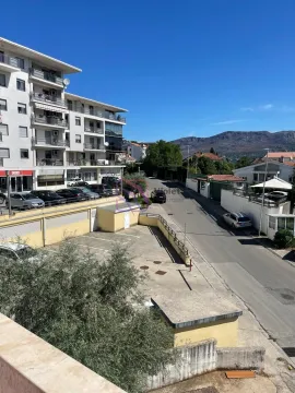 View from the terrace overlooking the street, parking lot, and surrounding buildings. - image 13