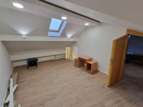 Empty attic room with a skylight and wooden flooring. - image 8