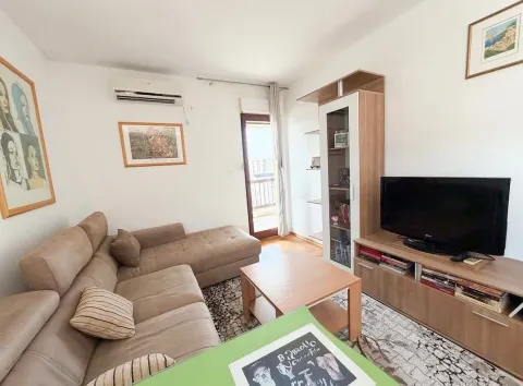 Living room with sofa, TV unit, and access to the terrace. - image 6