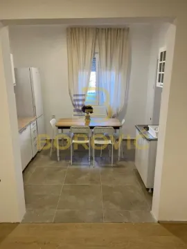 Kitchen with a dining area and a dining table. - image 4