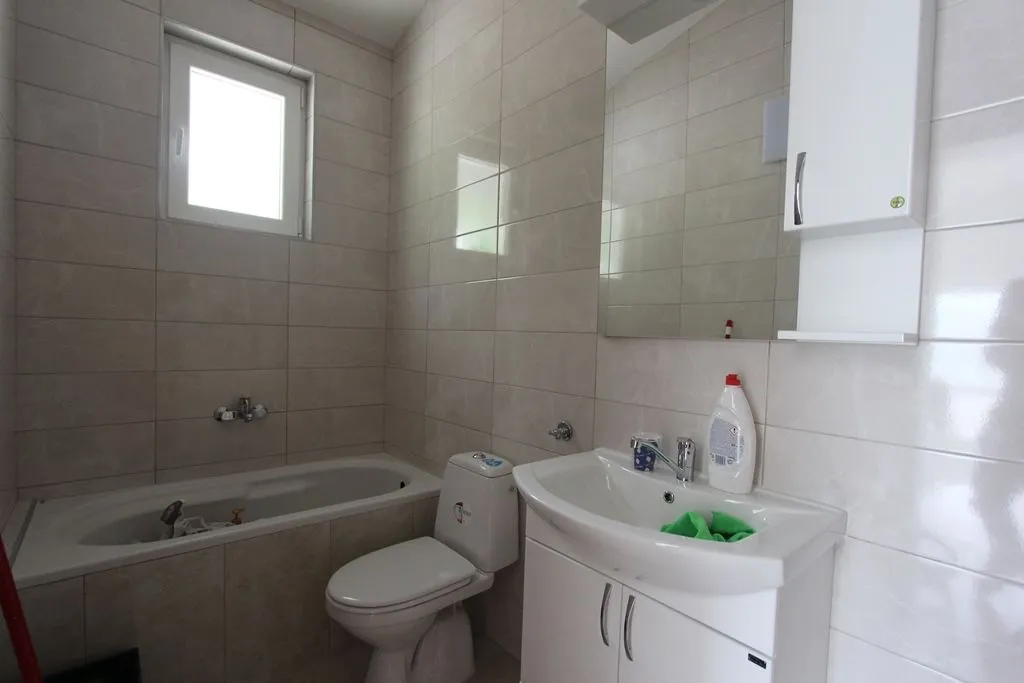 Bright bathroom with a bathtub and sink.