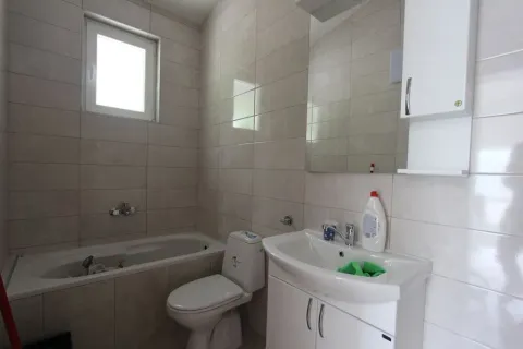 Bright bathroom with a bathtub and sink. - image 14