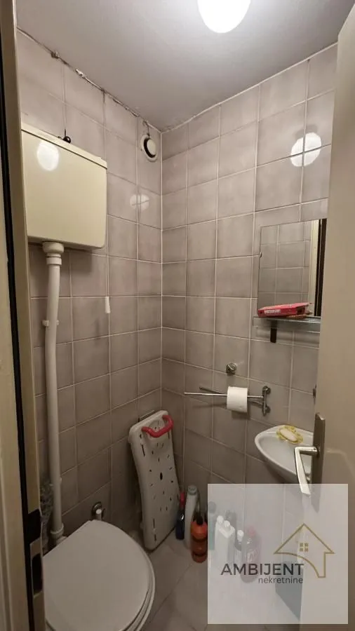 Small bathroom with sanitary ware and wall tiles.