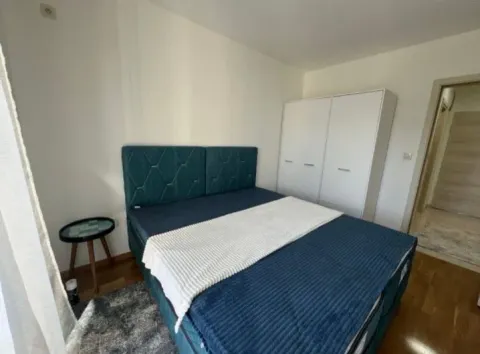 Namještena spavaća soba sa bračnim krevetom, bijelim ormarom i noćnim stočićem. - image 5