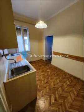Small kitchen with a sink, cabinets, and parquet flooring. - image 6