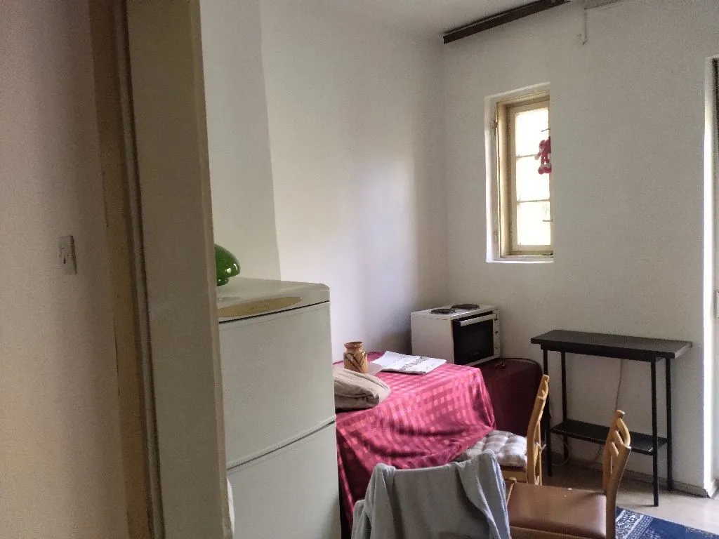 Small kitchen with a dining table and window.