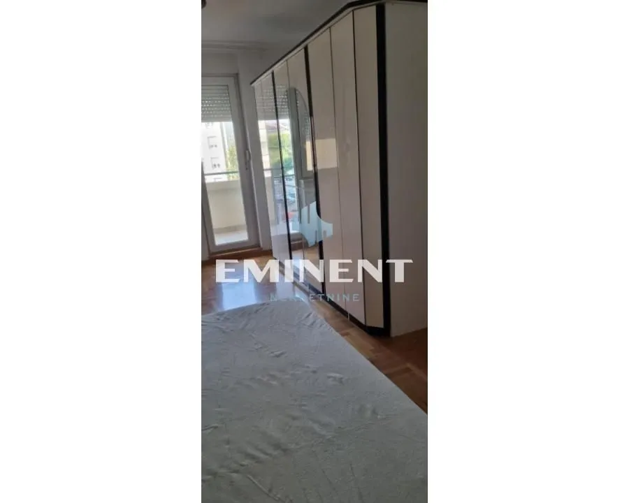 Bedroom with a large wardrobe and balcony access.