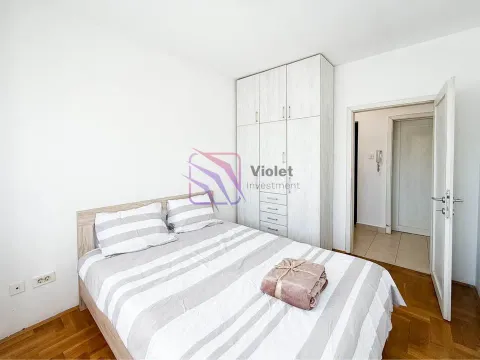Bedroom with a double bed, built-in wardrobe, and an open door leading to the hallway. - image 8