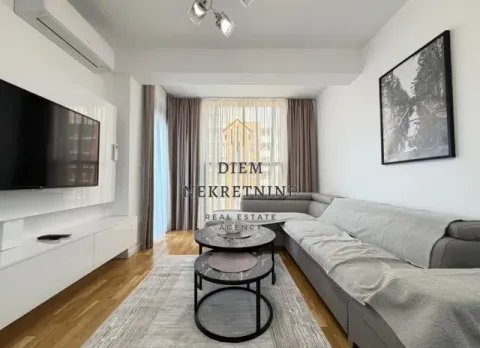 Living room with a corner sofa, television, and coffee table. - image 4