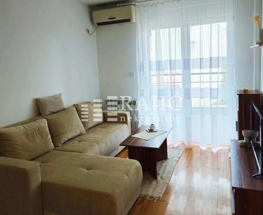 Living room with a sofa and access to the terrace.