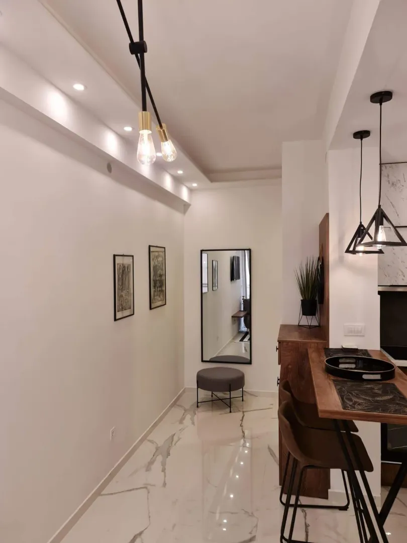 Modern kitchen with a bar counter and dining table.