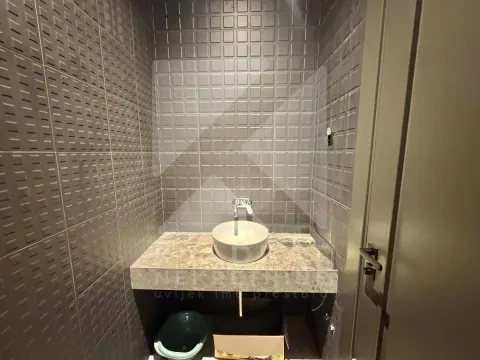 Small bathroom with a washbasin and gray wall tiles. - image 19