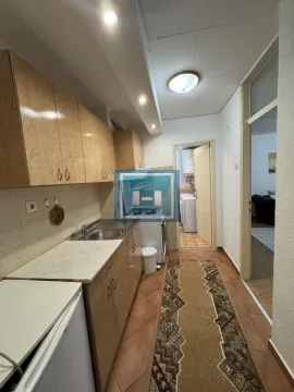 Small kitchen with wooden cabinets and tiled floors. - image 3