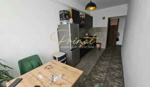 Small kitchen with a dining table and black kitchen units. - image 6