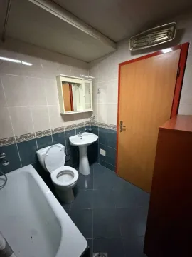 Smaller equipped bathroom with a bathtub, sink, and toilet. - image 12