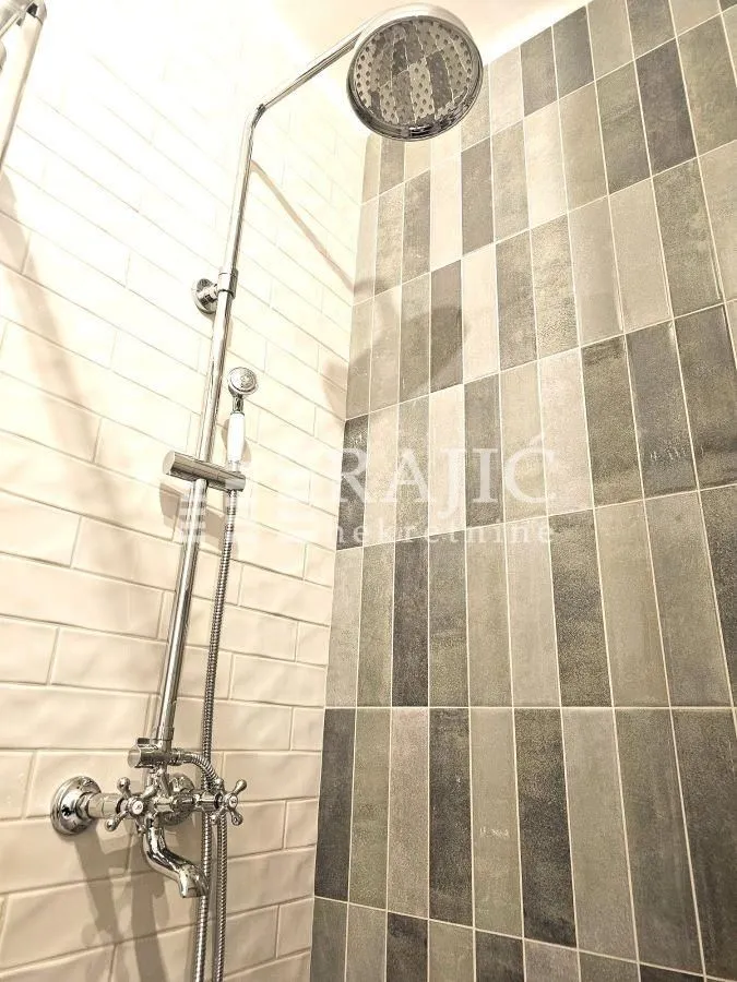 Modern ceramic tiles and a shower cabin in the bathroom.