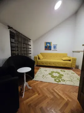 Living room with a yellow sofa and black armchairs. - image 11