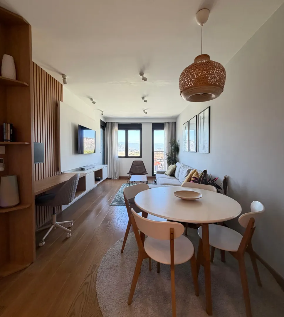 Modern living room with a dining area and a workspace.