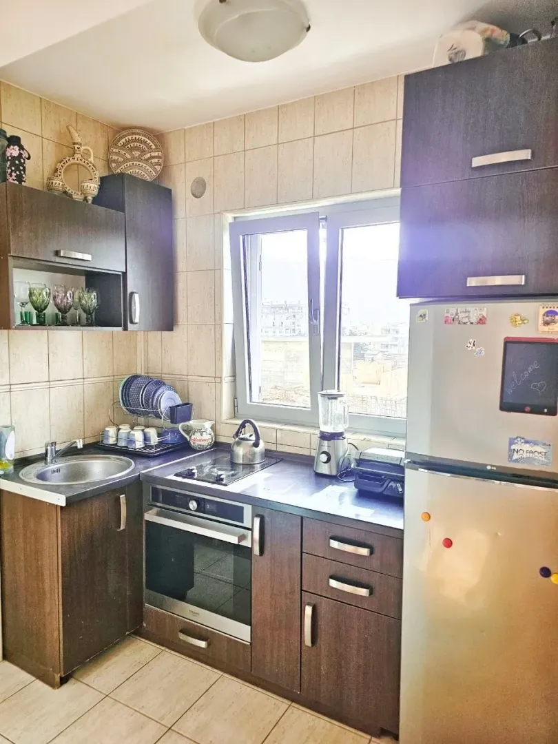Small kitchen with dark cabinets and a sink next to the window.