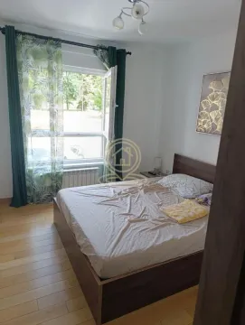 Furnished bedroom with a double bed and a window. - image 3