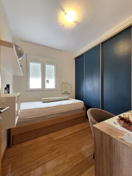Children's bedroom with a bed, large wardrobe, and a desk. - image 4