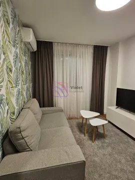Living room with a grey sofa, TV unit, and botanical-patterned wallpaper. - image 14
