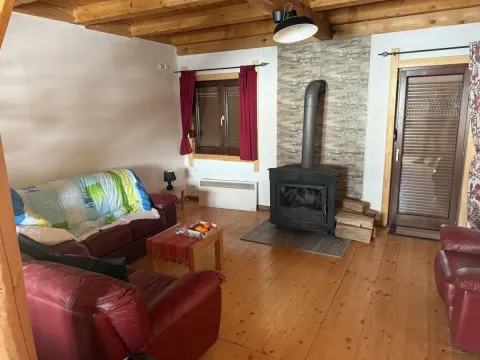 Living room with a fireplace and wooden floor. - image 2