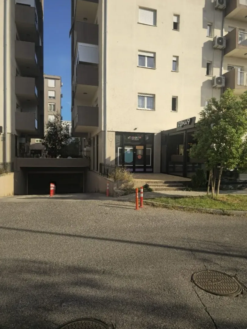 Exterior of a residential building with a garage entrance.
