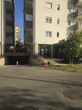 Exterior of a residential building with a garage entrance. - image 6