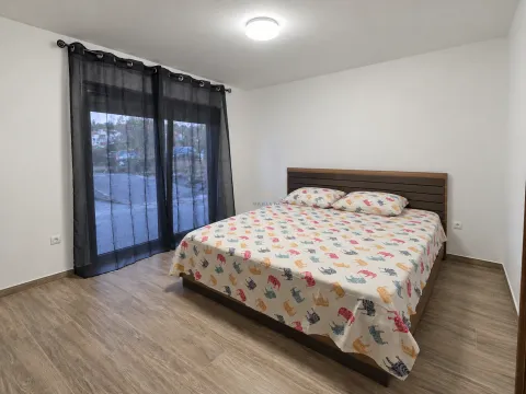 Bedroom with a double bed and balcony doors. - image 5