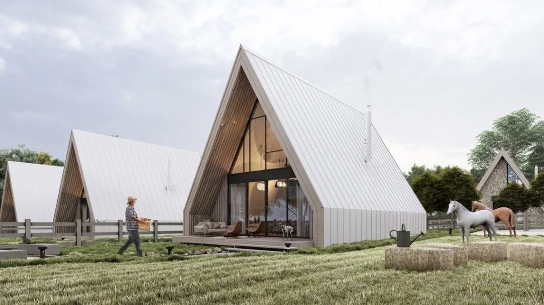 Exterior view of modern A-frame houses with a landscaped yard.