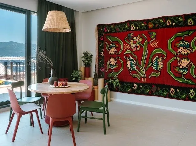 Bright living room with a dining table and a large window with a view.
