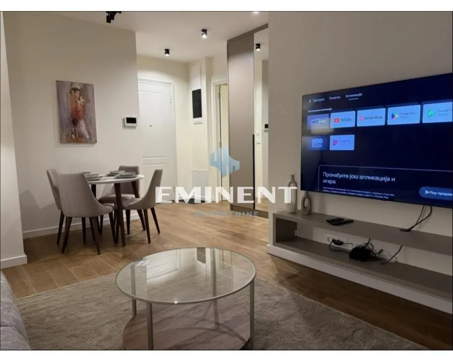 Living room with dining area and TV.