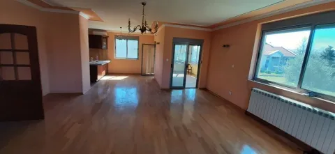 Spacious empty living room with hardwood floors, a chandelier, and balcony access. - image 7