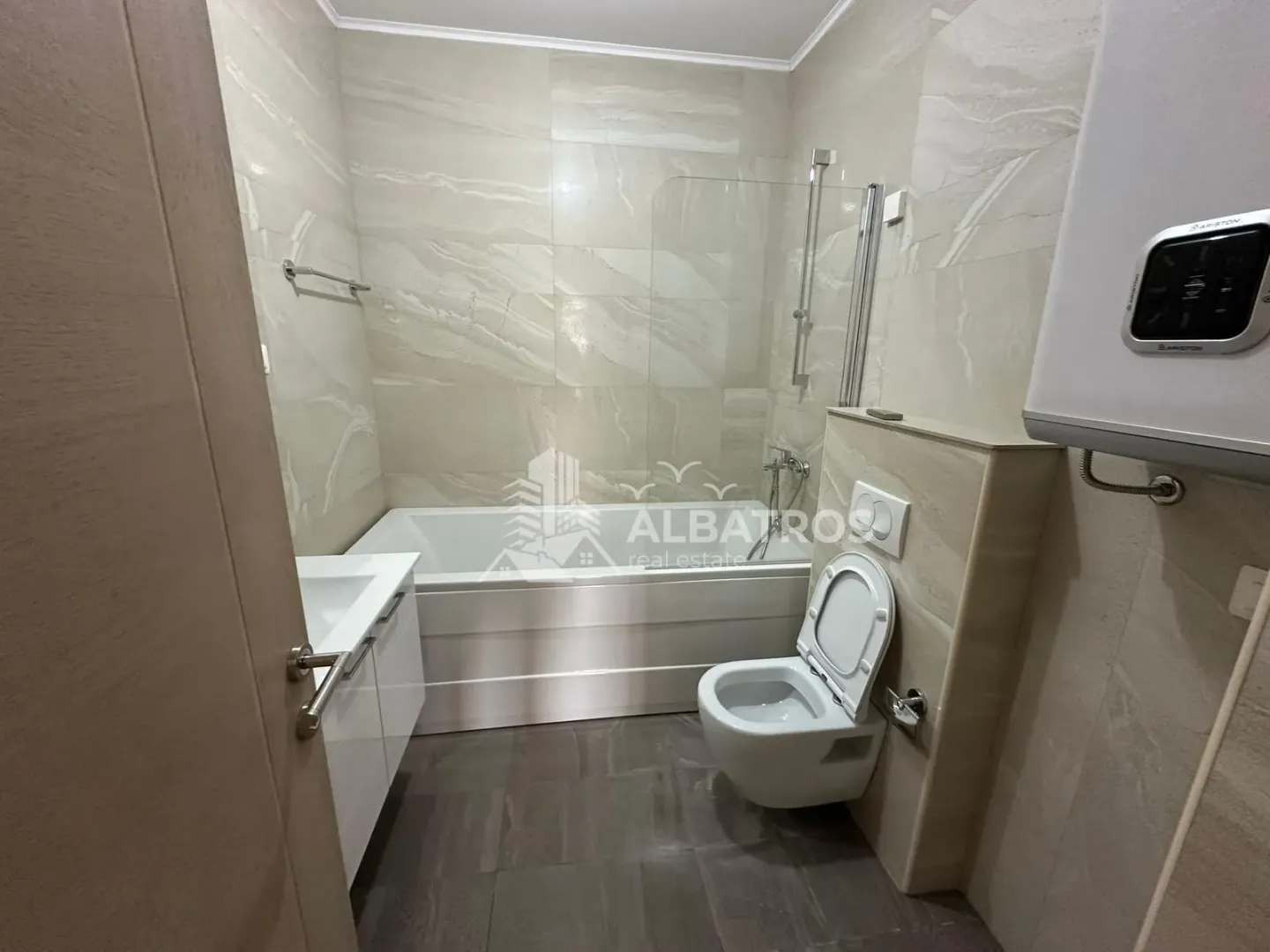 Savremeno opremljeno kupatilo sa kadom, tuš paravanom i ugradnom sanitarijom.
