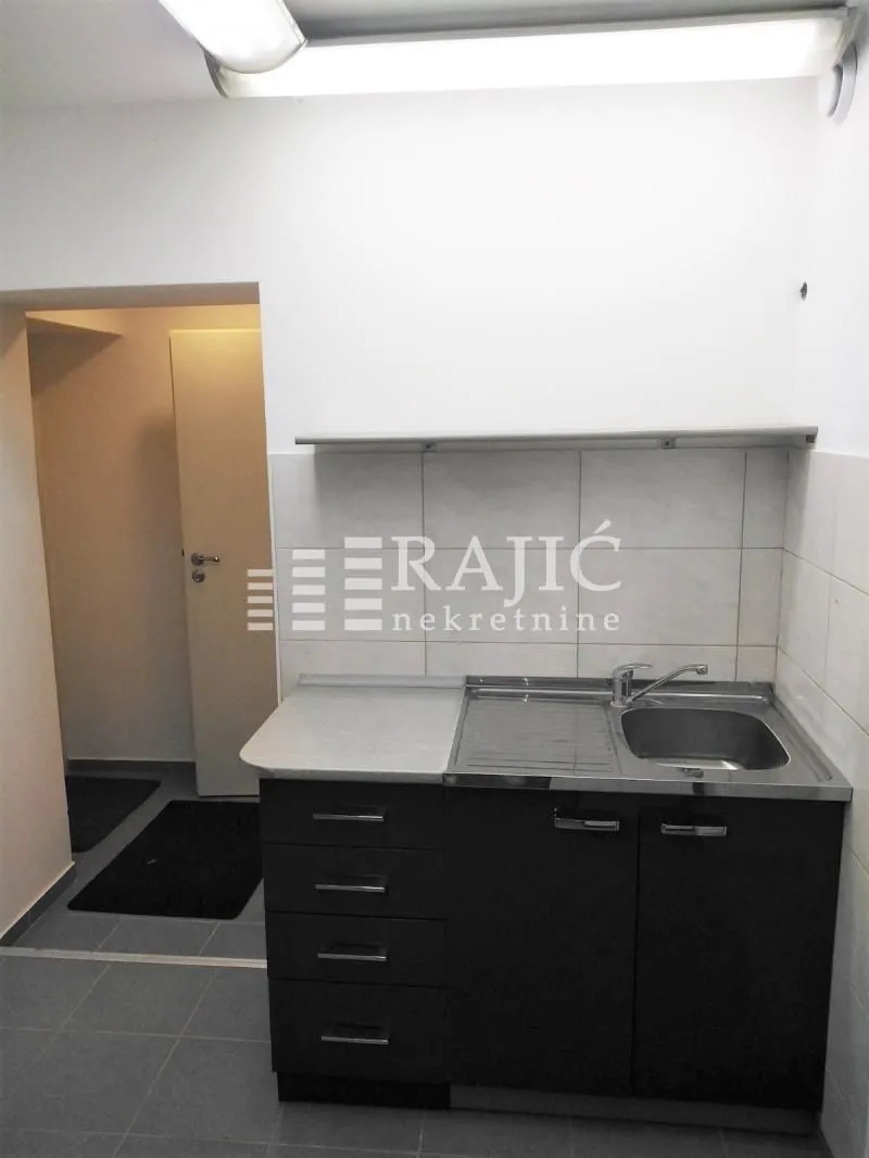 Small kitchen with sink and cabinets.