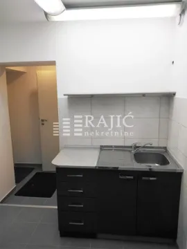 Small kitchen with sink and cabinets. - image 5