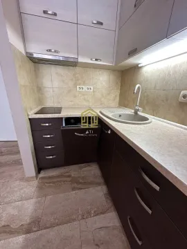 Small modern kitchen with dark and light cabinetry. - image 2
